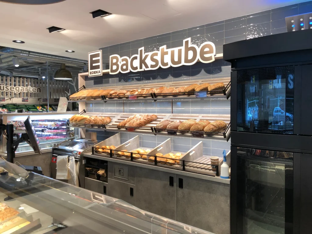 Backtheke mit Brotregal unter dem Schriftzug Backstube
