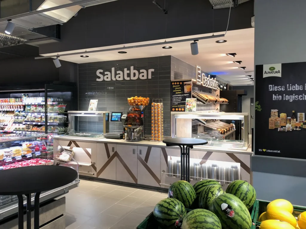 Salatbar mit Kühlregal und Obstpräsentation davor
